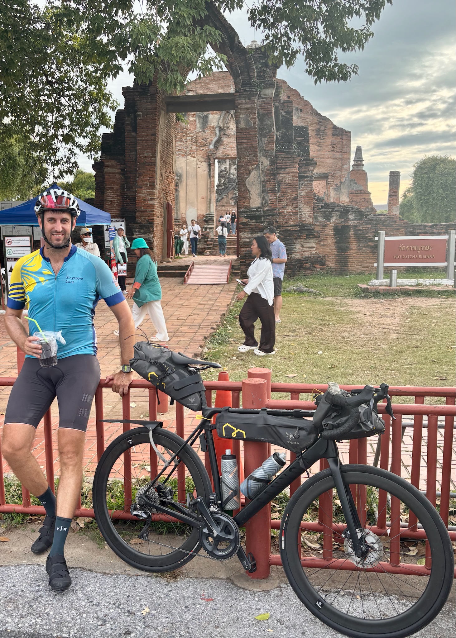 Matt with the loaded bike and an iced coffee at Wat Ratcha Burana, Ayutthaya