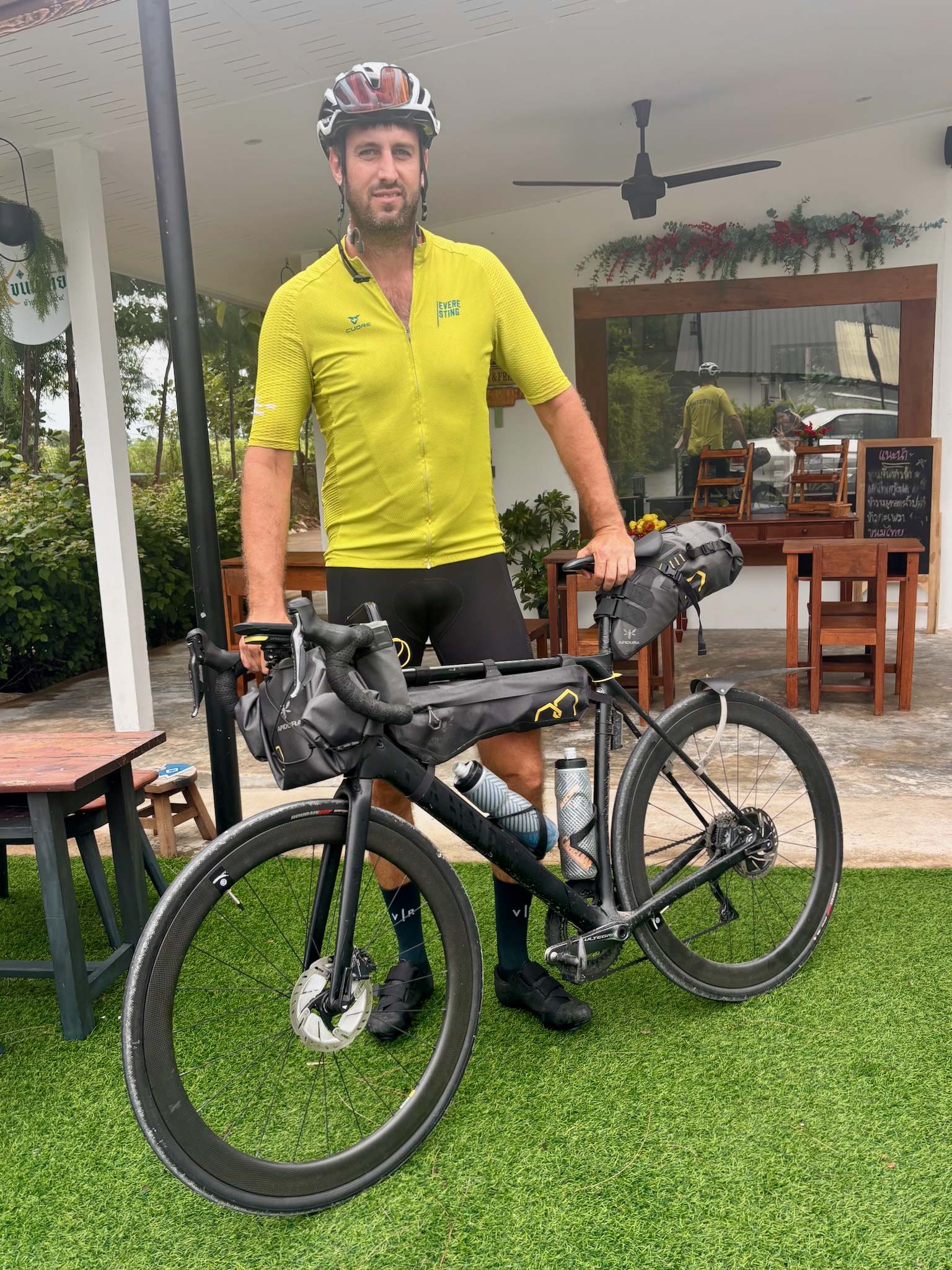Matt in a yellow jersey with the loaded bike at the Sala Daeng accommodation