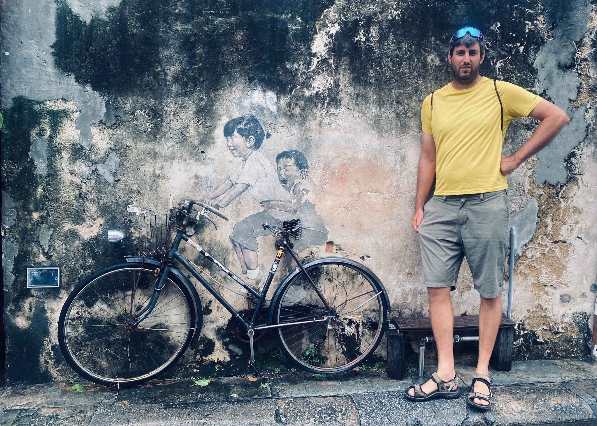 Standing beside the famous children-on-a-bicycle mural