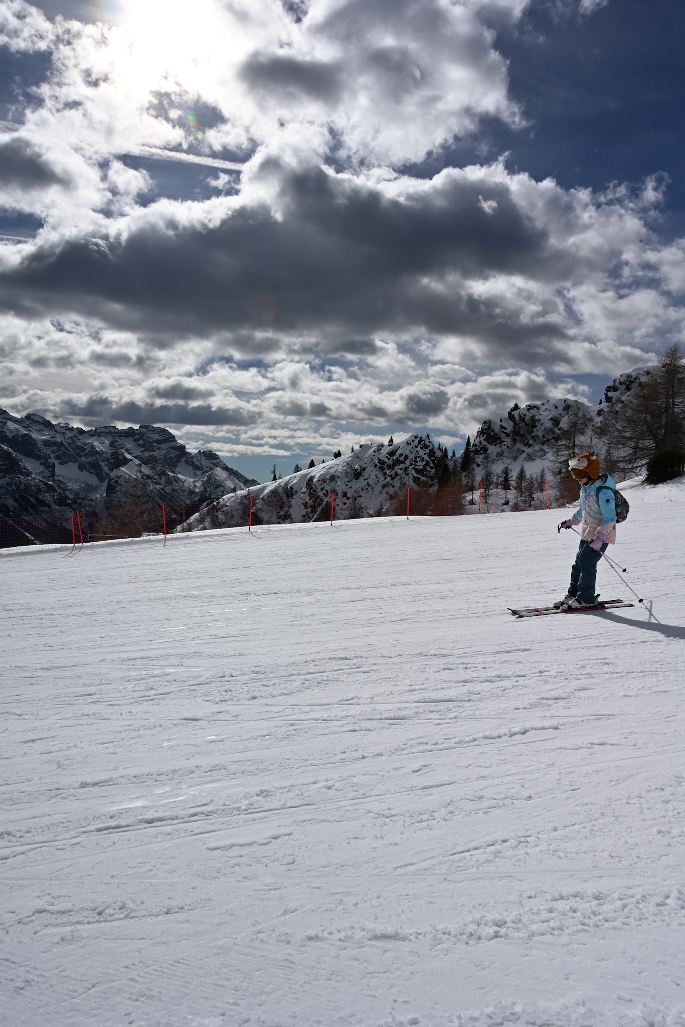 A young skier under a big Dolomites sky