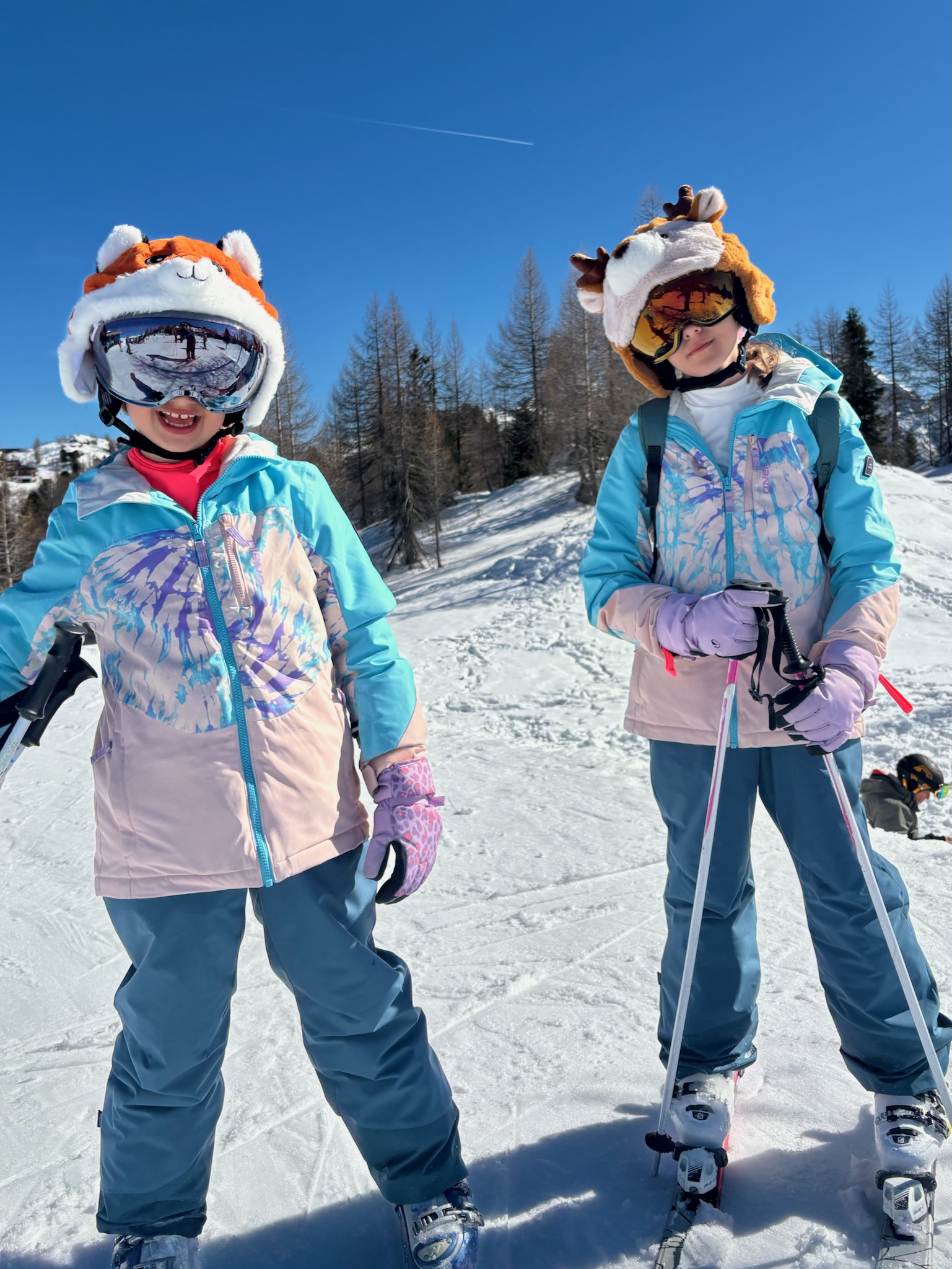 The two girls in animal helmet covers and goggles