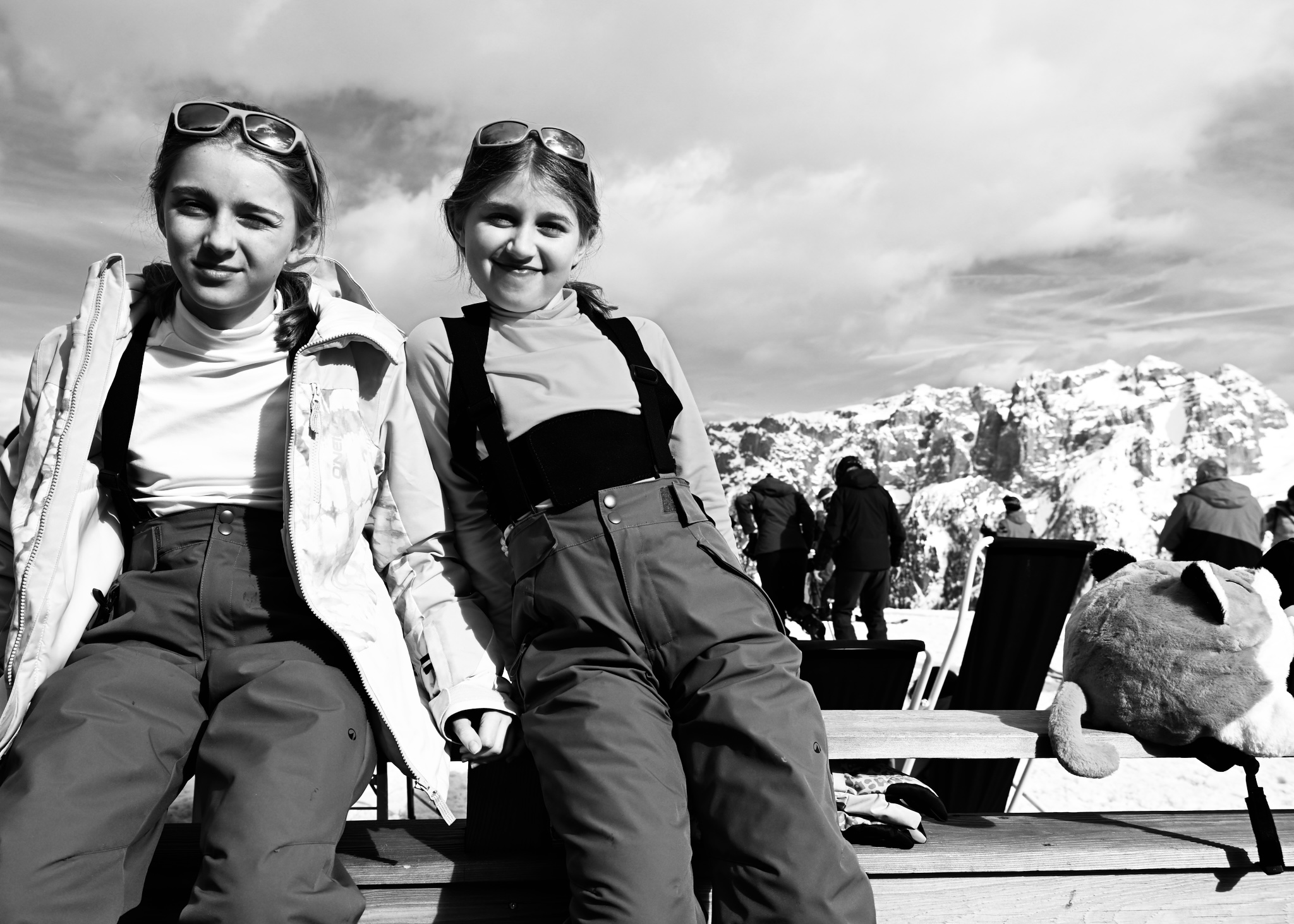 The two girls on a sun deck bench, black and white
