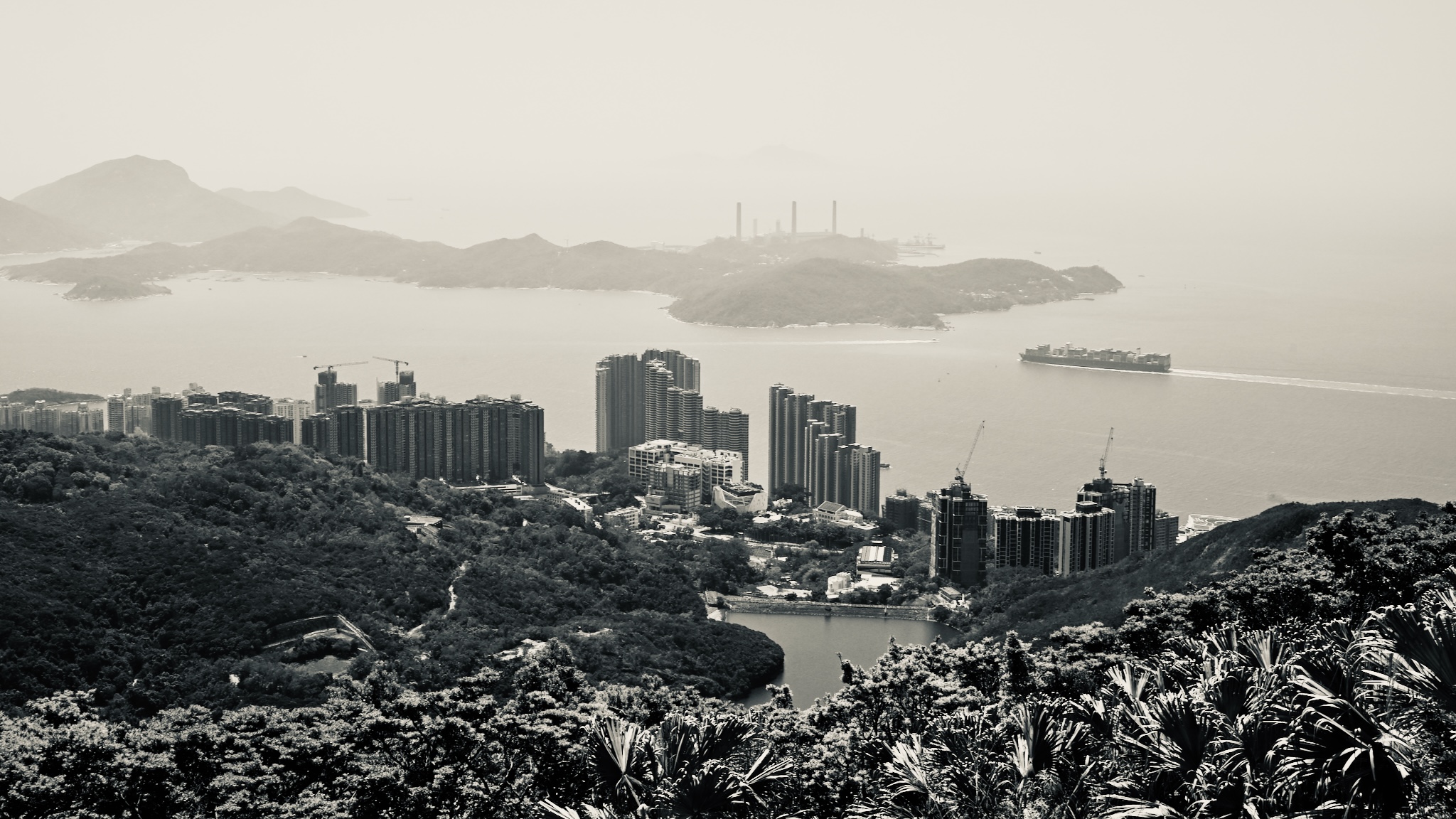 Harbour and high-rises in haze, black and white