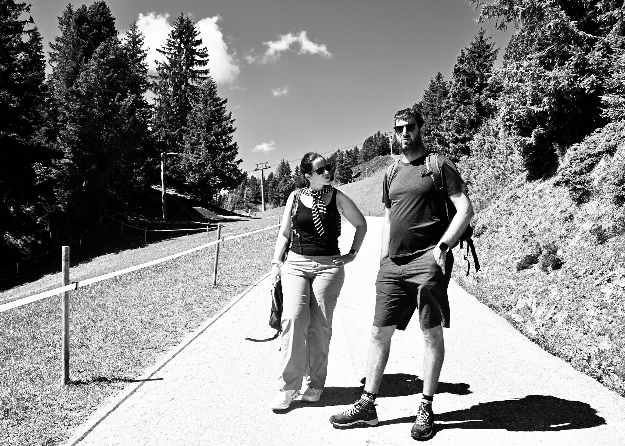 Two walkers on a mountain path, black and white