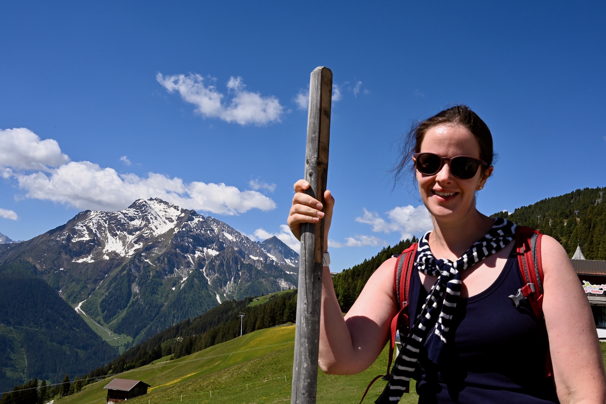 Caroline with a walking stick, mountains behind