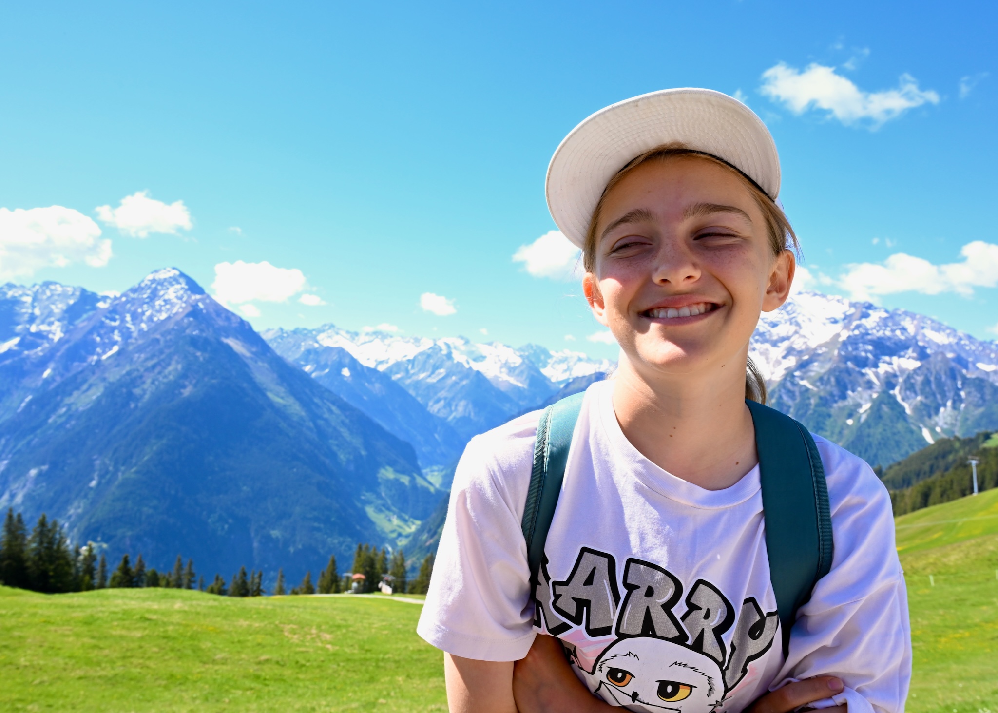 Elizabeth grinning in the sun, mountains behind