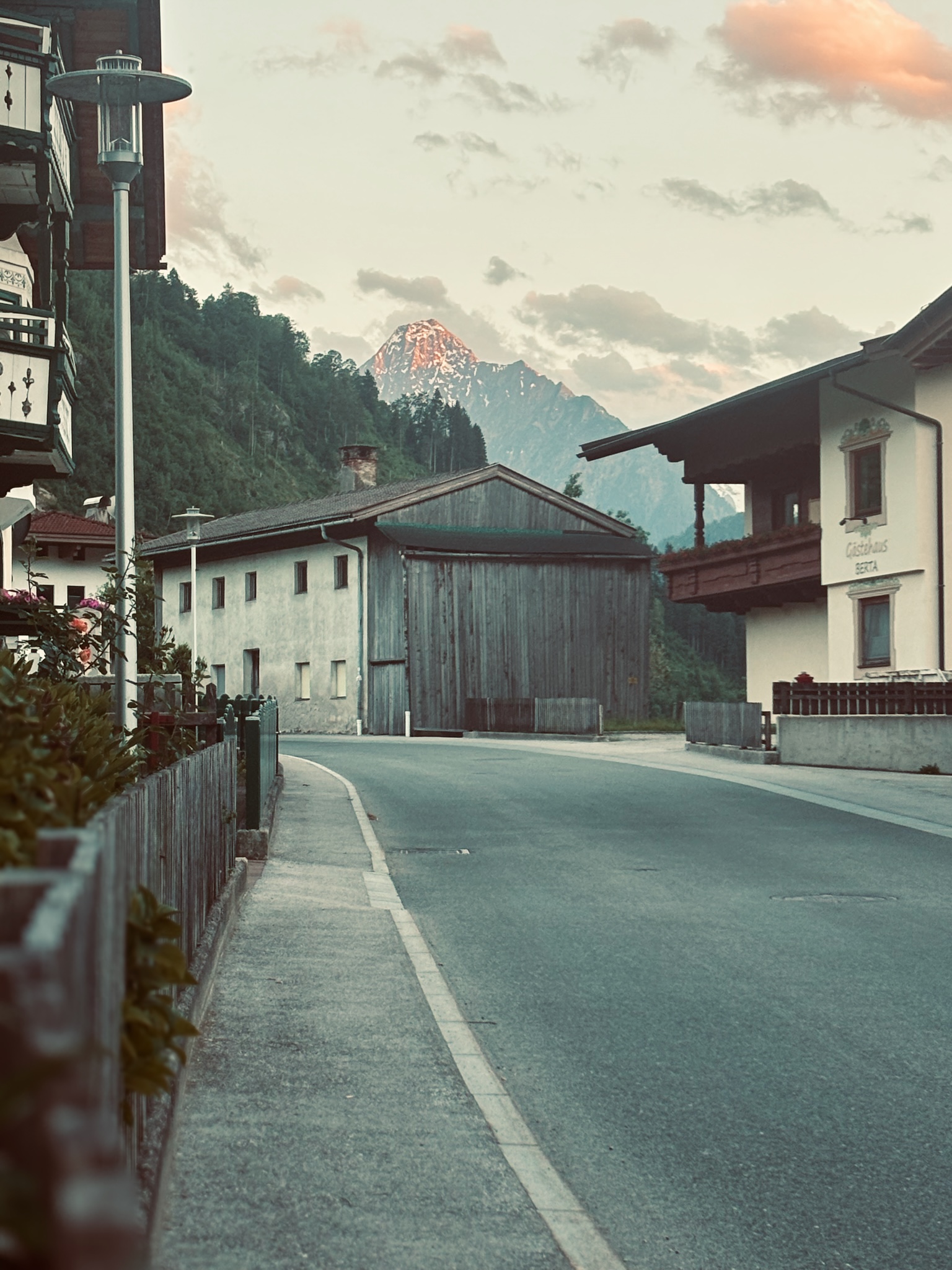Alpenglow on the peak above the village street at dusk