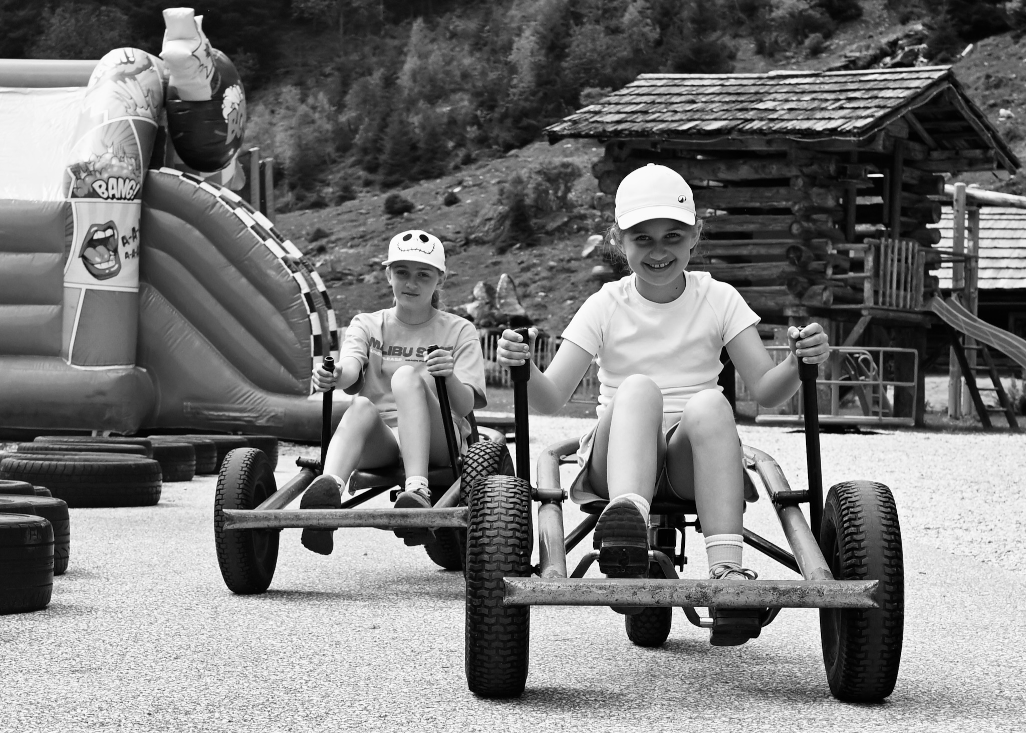The girls racing pedal go-karts, black and white