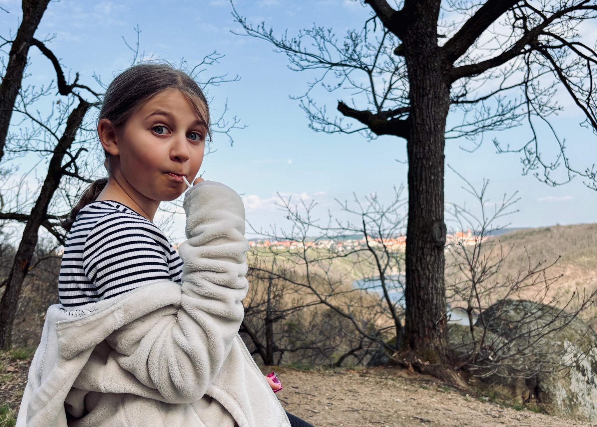 A daughter with a lollipop, the valley behind