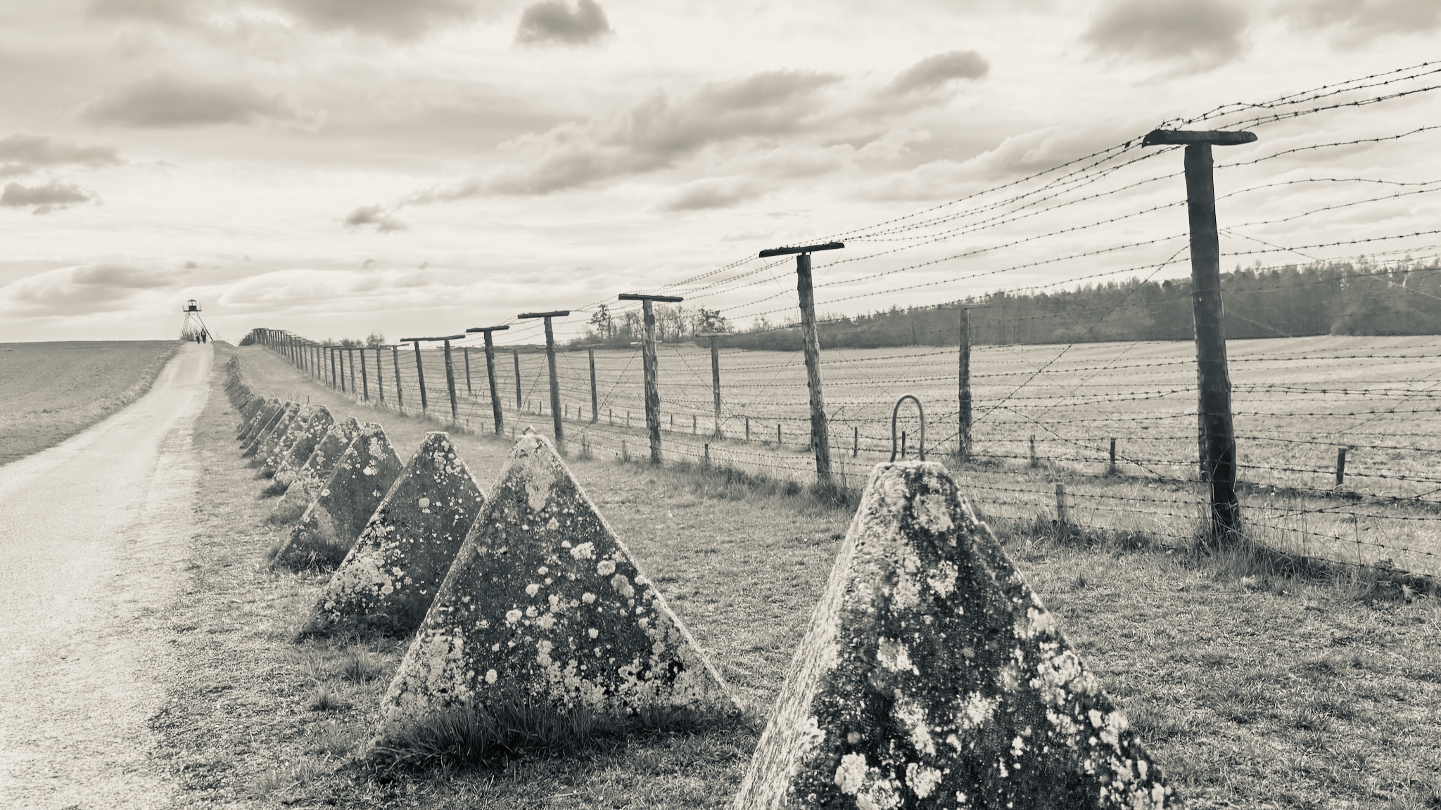 The old Iron Curtain fence and anti-tank obstacles, black and white