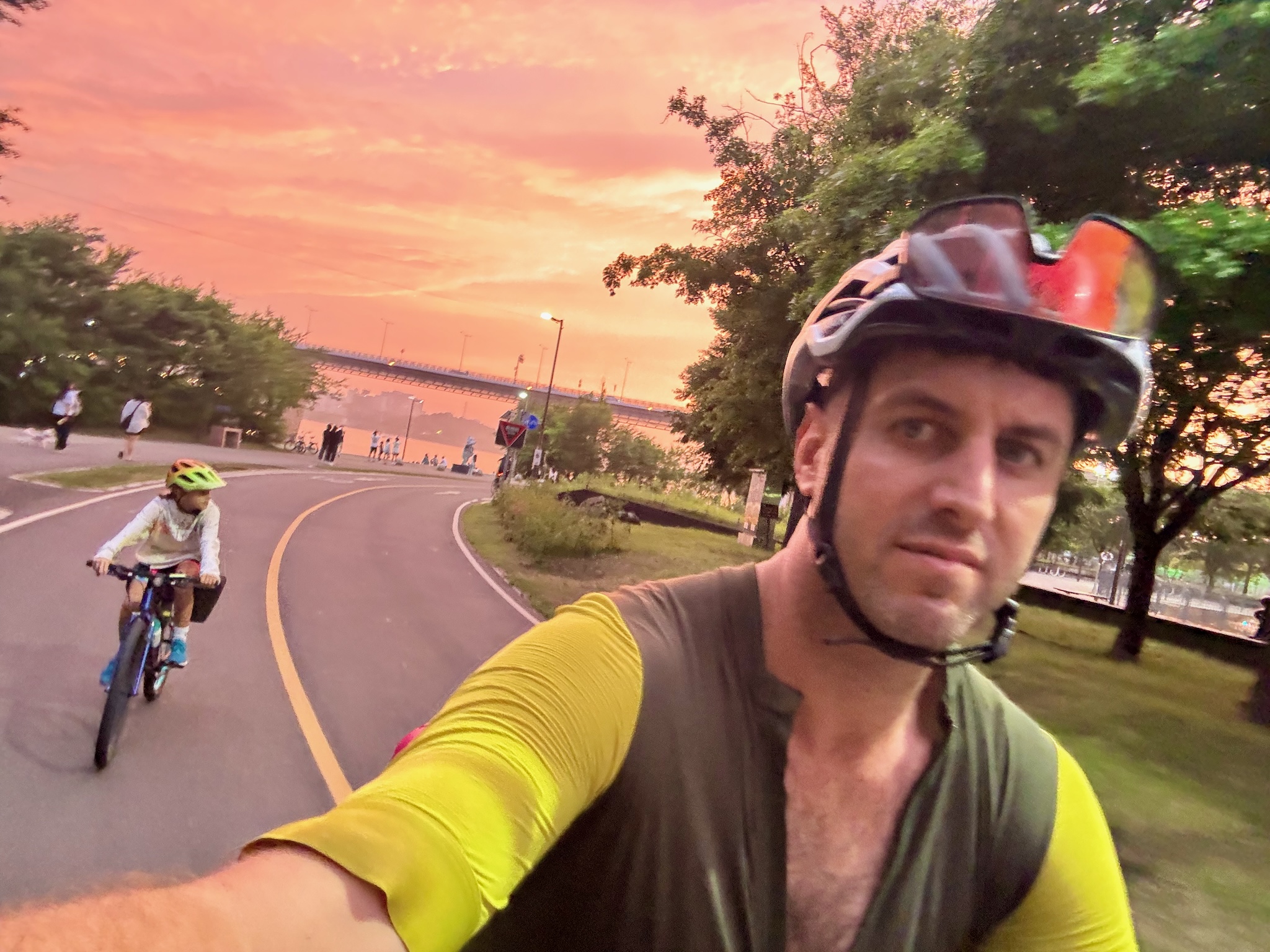 Riding into a pink sunset on the riverside path