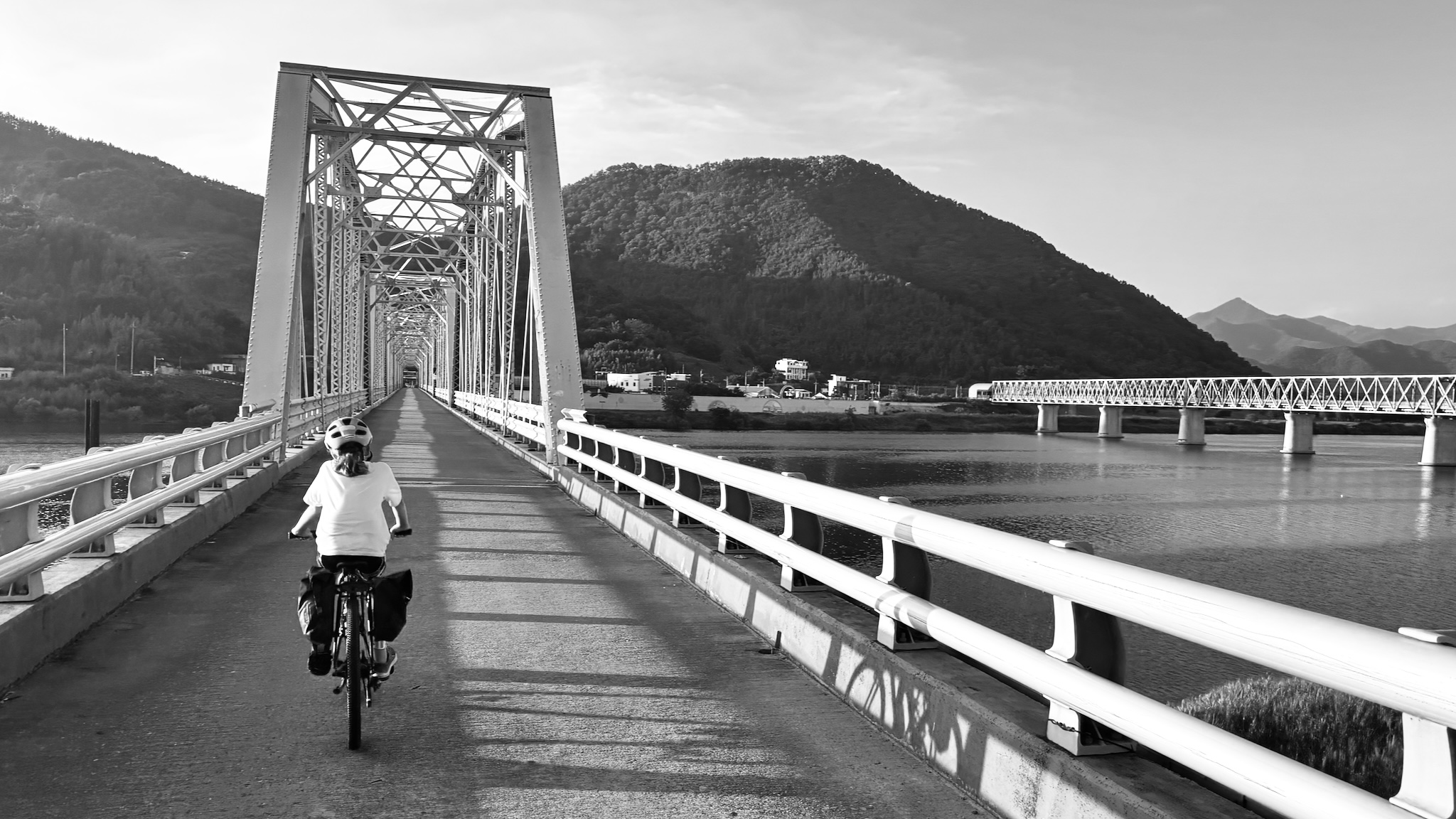 Crossing a long steel truss bridge over the river