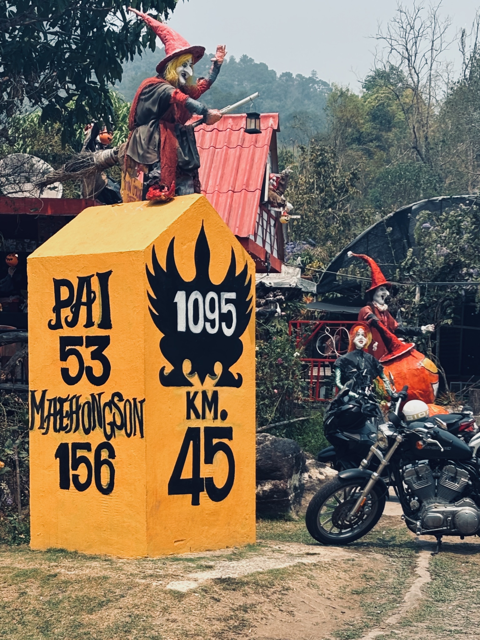 The painted 1095 milestone with a witch figure, Pai 53 km, Mae Hong Son 156 km